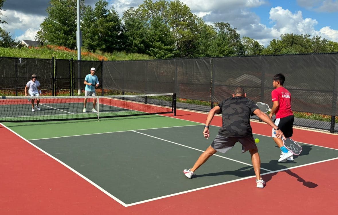 Pickleball players in action on outdoor courts
